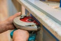 Carpenter using circular saw cutting cut hole in kitchen furniture