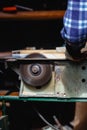 Carpenter using circular saw cutting wooden board in wood workshop Royalty Free Stock Photo