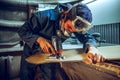 Carpenter using circular saw for cutting wooden boards. Royalty Free Stock Photo