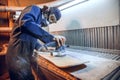 Carpenter using circular saw for cutting wooden boards. Royalty Free Stock Photo