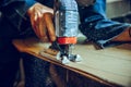 Carpenter using circular saw for cutting wooden boards. Royalty Free Stock Photo