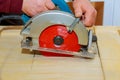 Carpenter using circular saw cutting wooden boards with power tools. Royalty Free Stock Photo