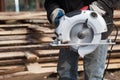 Carpenter Using Circular Saw works outdoors Royalty Free Stock Photo