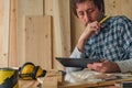 Carpenter using digital tablet in small business woodwork workshop Royalty Free Stock Photo