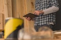 Carpenter using digital tablet in small business woodwork workshop Royalty Free Stock Photo