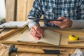 Carpenter using digital tablet to complete project to do list Royalty Free Stock Photo