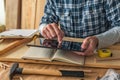 Carpenter using digital tablet to complete project to do list Royalty Free Stock Photo