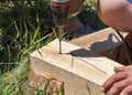 Carpenter using drill and on wood outdoor Royalty Free Stock Photo