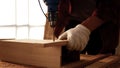 Carpenter using drill to screwing pieces of board Royalty Free Stock Photo