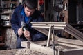 Carpenter using Hammer and Chisel in Workshop Royalty Free Stock Photo