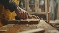 A carpenter using a handheld augmented reality device to detect any flaws or imperfections in a wooden board before ting