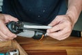 Carpenter using nail gun or brad nailer tool ,load a top loading stapler in a workshop ,furniture restoration woodworking concept