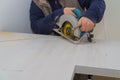 Carpenter using a saw to cut laminate counter top Royalty Free Stock Photo