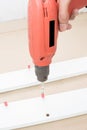 Carpenter using Screwdriver assemble furniture Royalty Free Stock Photo