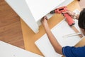 Carpenter using Screwdriver assemble furniture Royalty Free Stock Photo