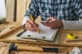 Carpenter using smart phone to complete project to do list