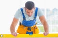 Carpenter using spirit level in office Royalty Free Stock Photo