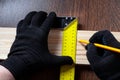 carpenter using Square ruler and pencil for measuring on wooden board. construction concept. Royalty Free Stock Photo