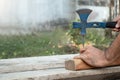 The carpenter was hammering nails into the wood with a hammer. Royalty Free Stock Photo