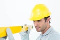 Carpenter wearing hard hat while using spirit level Royalty Free Stock Photo