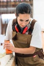 Carpenter woman working with planer in her workshop Royalty Free Stock Photo