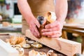 Carpenter with wood planer and workpiece in carpentry Royalty Free Stock Photo