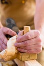 Carpenter with wood planer and workpiece in carpentry Royalty Free Stock Photo