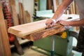 Carpenter or woodworker measuring a block of wood Royalty Free Stock Photo