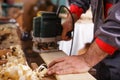 Carpenter at work with electric planer joinery Royalty Free Stock Photo