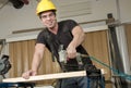 Carpenter at work on job using power tool Royalty Free Stock Photo