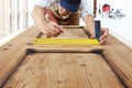 Carpenter at work measures with the setsquare and pencil on wood Royalty Free Stock Photo