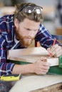 Carpenter at work measures with tape measure Royalty Free Stock Photo