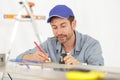 Carpenter at work measures with tape measure and pencil Royalty Free Stock Photo