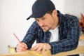 carpenter at work measures with tape measure and pencil Royalty Free Stock Photo