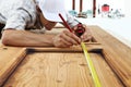 Carpenter at work measures with the tape measure and pencil on w Royalty Free Stock Photo