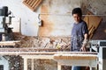 Carpenter at work sanding the wood with sanding machine blurry background. r Royalty Free Stock Photo