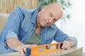 carpenter at work with spirit level on wood Royalty Free Stock Photo