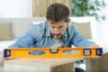 carpenter at work with spirit level on wood background Royalty Free Stock Photo