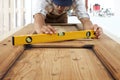 Carpenter at work with spirit level on wood background Royalty Free Stock Photo