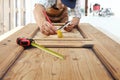 Carpenter work the wood, measuring a wooden vintage door Royalty Free Stock Photo