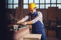 Carpenter work on wood plank in workshop Royalty Free Stock Photo