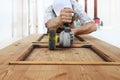 Carpenter work the wood with the sander grinding electric tools Royalty Free Stock Photo