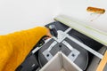 Carpenter worker holding in cordless hand drill installation of rotating baskets Royalty Free Stock Photo