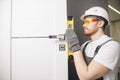 Carpenter worker installation process of wood door hinge tool level