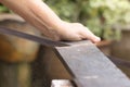 Carpenter worker sawing wood board with hand saw Royalty Free Stock Photo