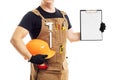 Carpenter in workers apron showing blank clipboard on white background Royalty Free Stock Photo