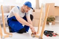 Carpenter Working Assembling Desk Installing Furniture After Relocation Indoor