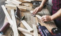 Carpenter working carpentry workshop Man sanding manually plank Royalty Free Stock Photo