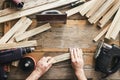 Carpenter working carpentry workshop Man sanding manually plank top view Royalty Free Stock Photo