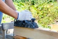 Carpenter working with electric planer on wooden plank Royalty Free Stock Photo